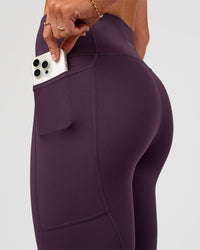 Woman wearing Rep Ultra High-Rise 7/8 Legging Pockets - Midnight Plum-Marshmallow | Model:Emelia | Size:S | Thumbnail Index: 2
