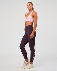 Woman wearing Rep Ultra High-Rise 7/8 Legging Pockets - Midnight Plum-Marshmallow | Model:Emelia | Size:S | Thumbnail Index: 0