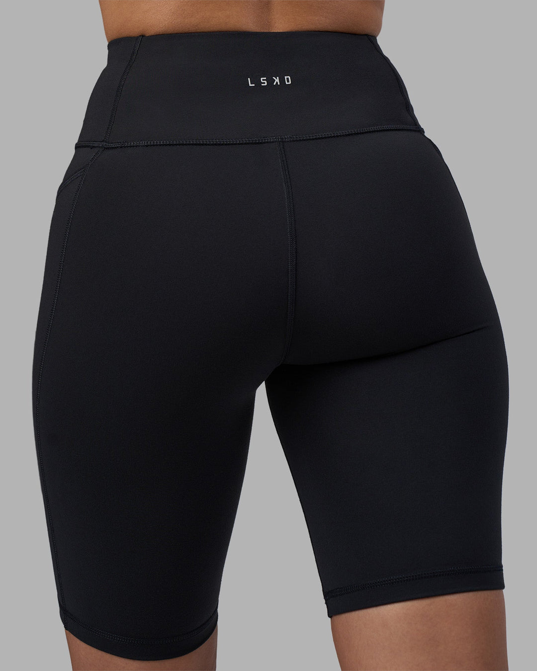Woman wearing Rep Ultra High-Rise 9&quot; Short Pockets - Black-Power Cobalt | Model:Rhiley | Size:S