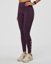 Woman wearing Rep Ultra High-Rise Full Length Legging Pockets - Midnight Plum-Marshmallow | Model:Rhiley | Size:S