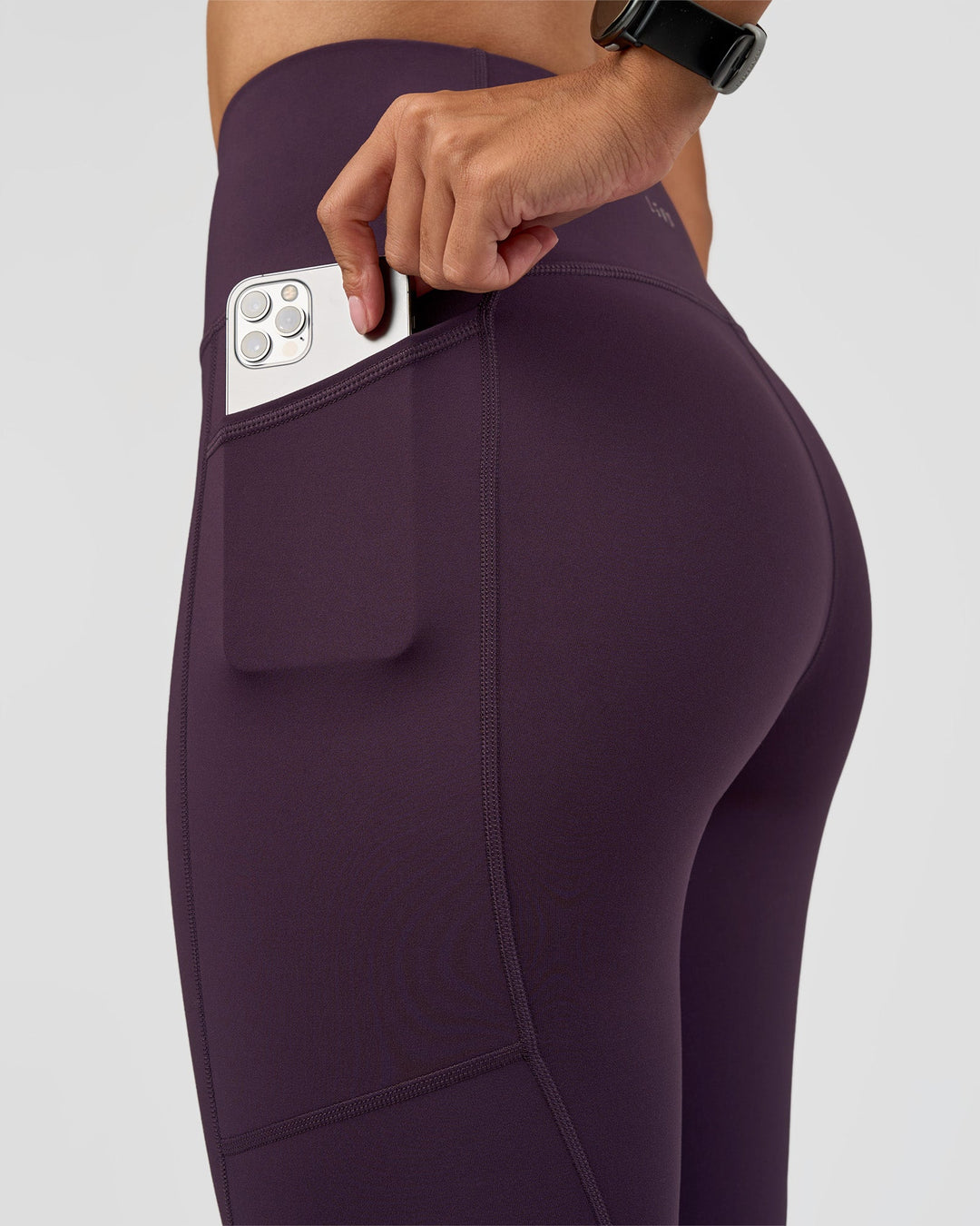 Woman wearing Rep Ultra High-Rise Full Length Legging Pockets - Midnight Plum-Marshmallow | Model:Rhiley | Size:S