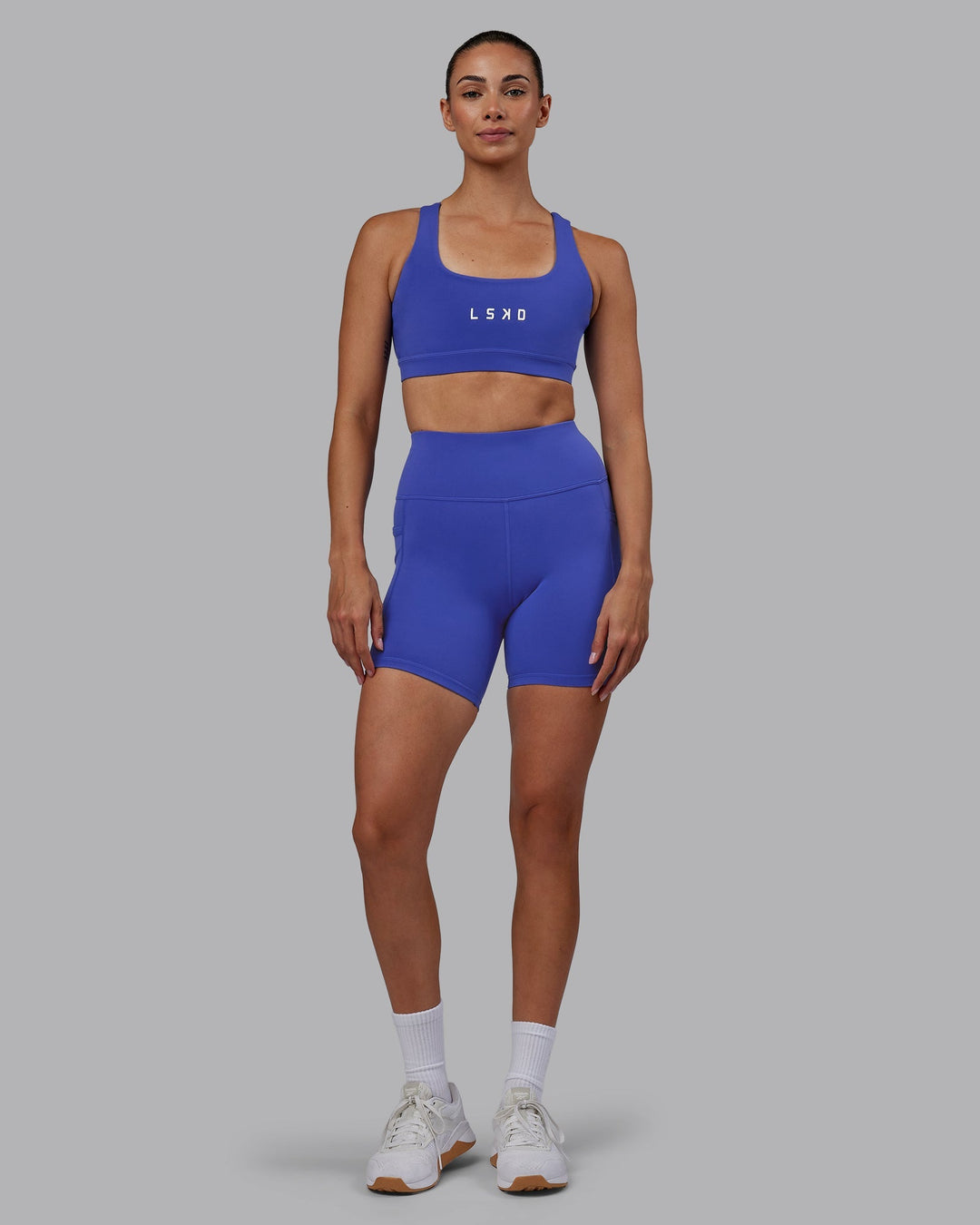 Woman wearing Rep Mid-Length Shorts - Power Cobalt-White