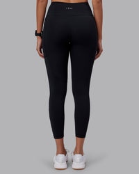 Woman wearing Rep Ultra High-Rise 7/8 Legging Pockets - Black-Black | Model:Rhiley | Size:S