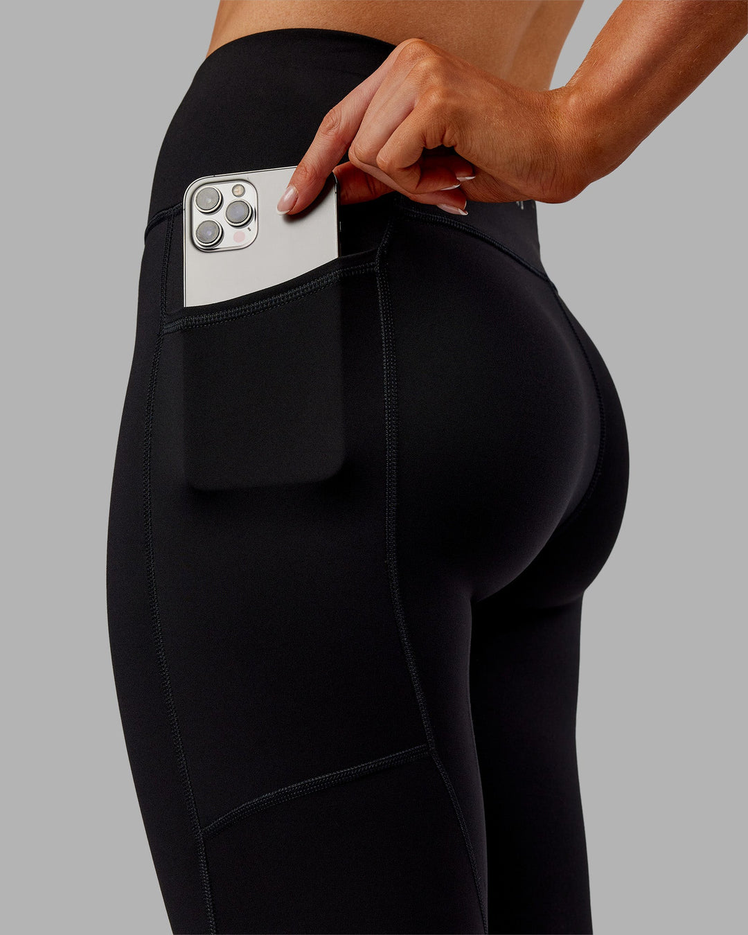 Woman wearing Rep Ultra High-Rise 7/8 Legging Pockets - Black-Ultra Orange | Model:Ella | Size:S