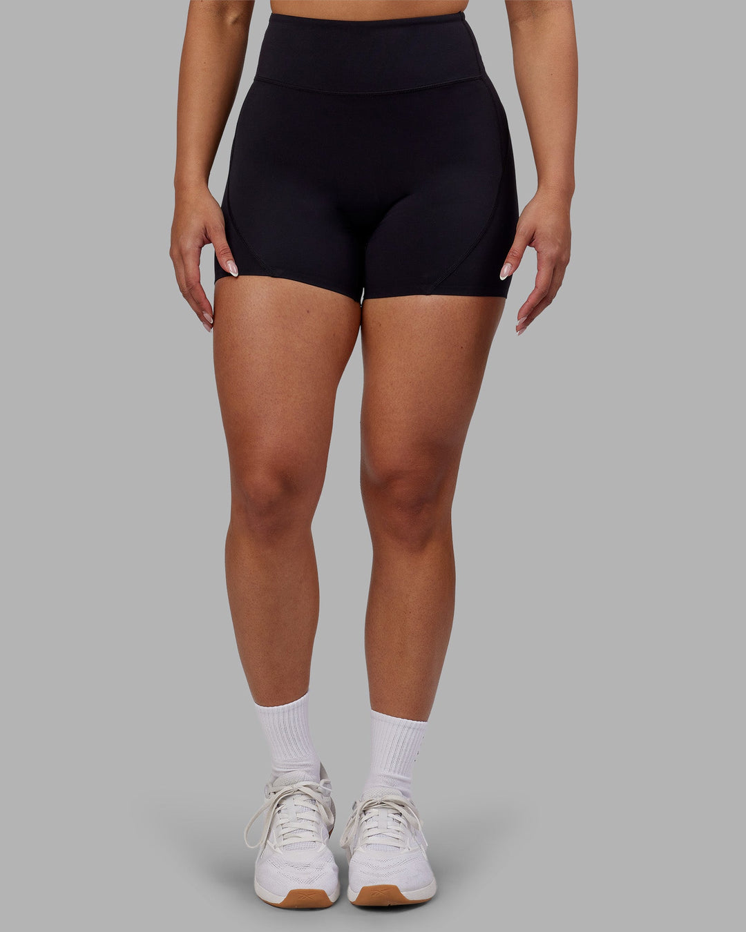 Woman wearing Rhythm Elixir Ultra High-Rise 4&quot; Short - Black | Model:Ayla | Size:S