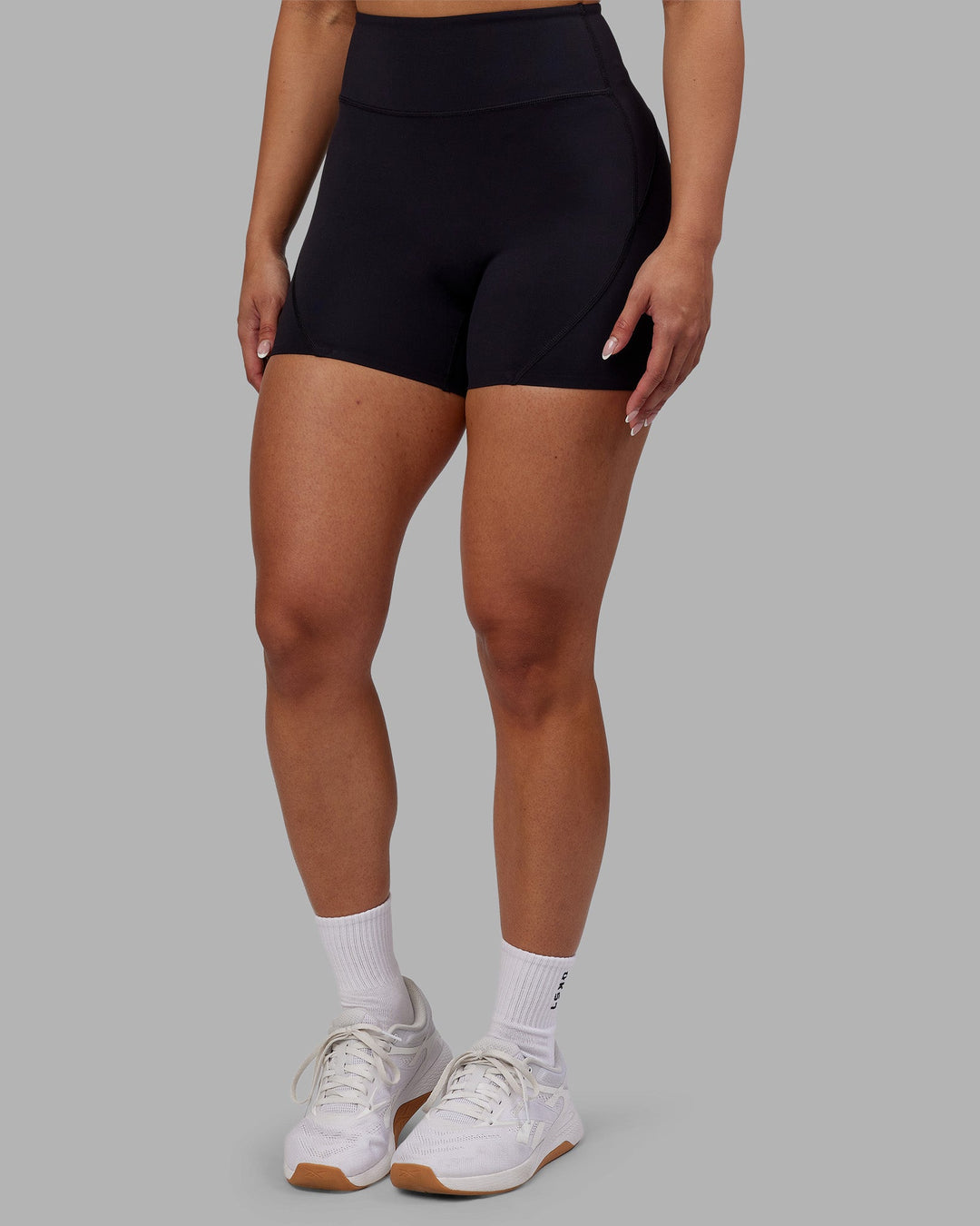 Woman wearing Rhythm Elixir Ultra High-Rise 4&quot; Short - Black | Model:Ayla | Size:S