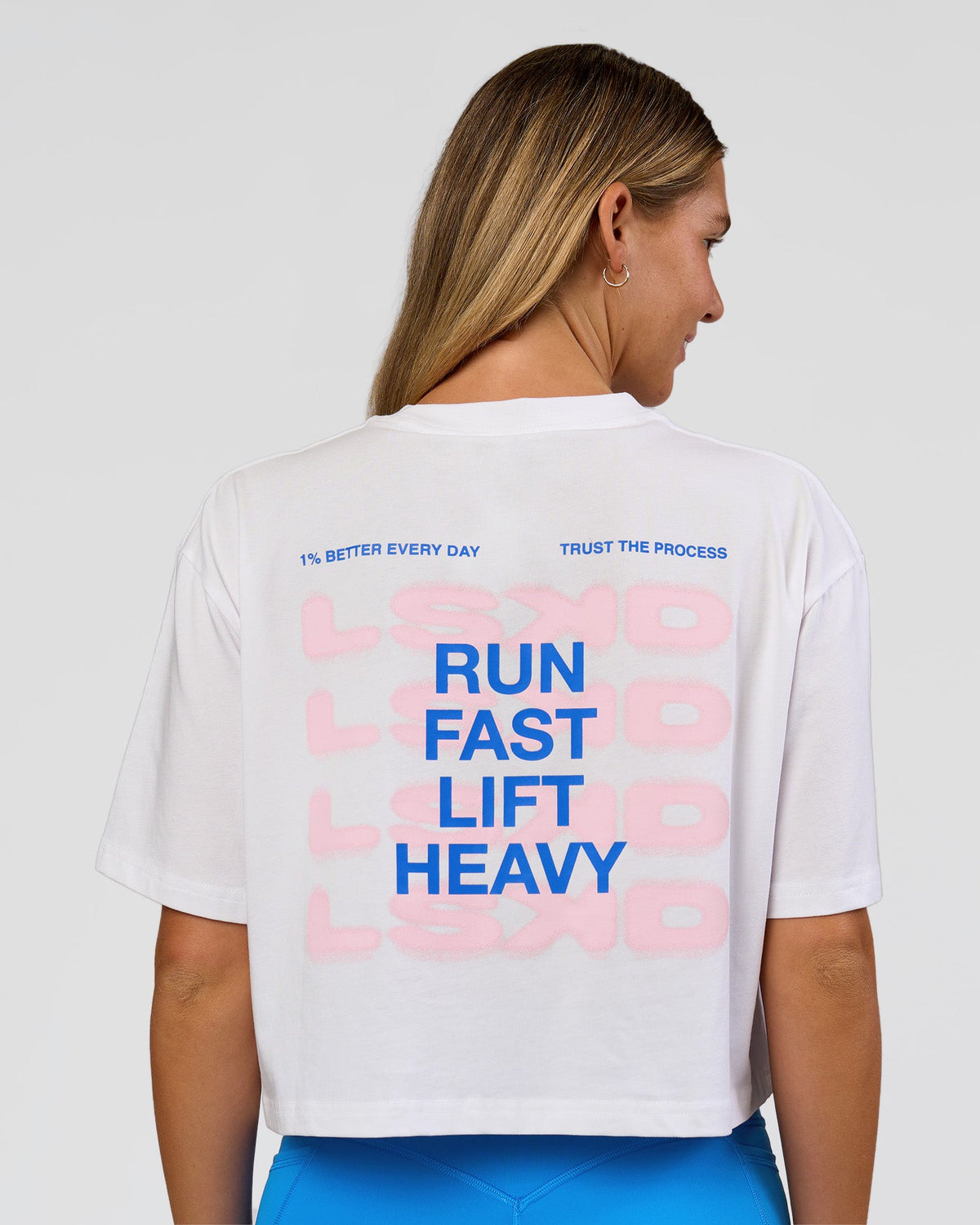 Woman wearing Run Fast Lift Heavy FLXCotton Cropped Tee - White | Model:Amity | Size:S - view 1