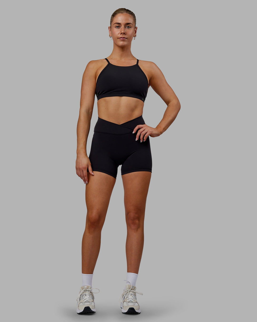 Woman wearing Sara Ares High Neck Sports Bra - Black