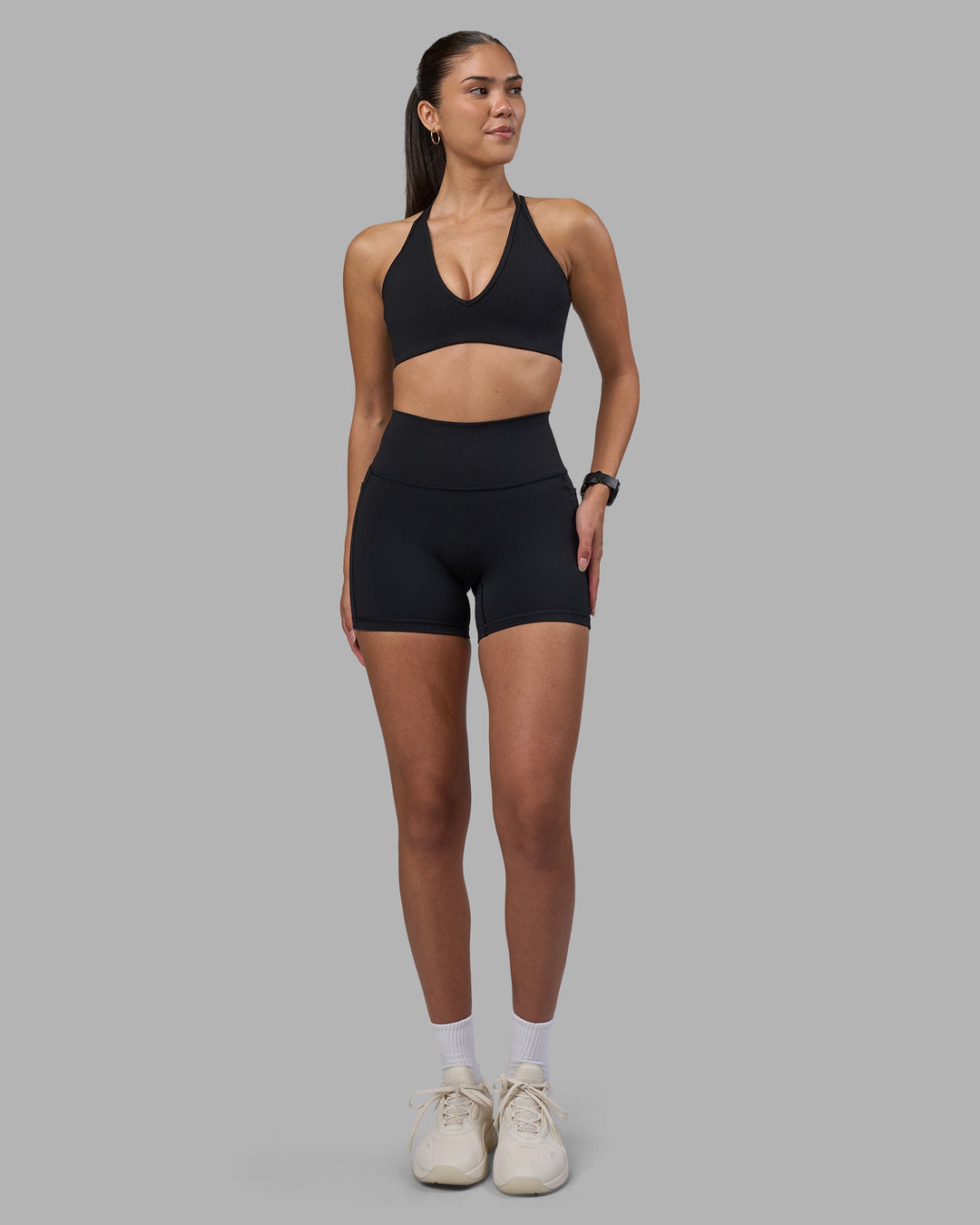Woman wearing Stamina Pulse Sports Bra - Black | Model:Rhiley | Size:S