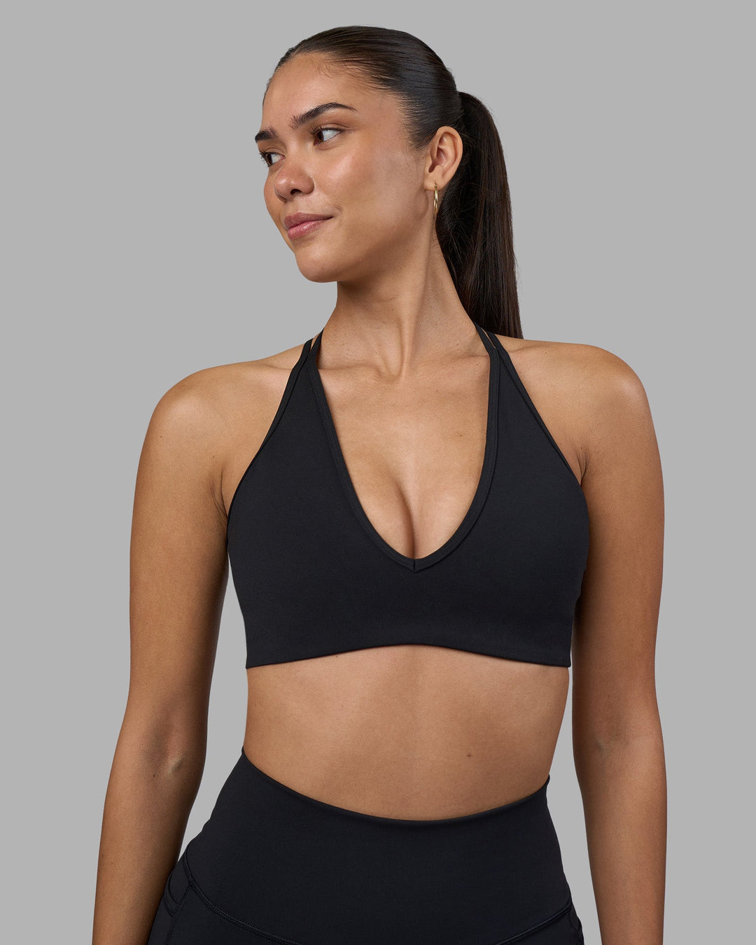 Woman wearing Stamina Pulse Sports Bra - Black | Model:Rhiley | Size:S