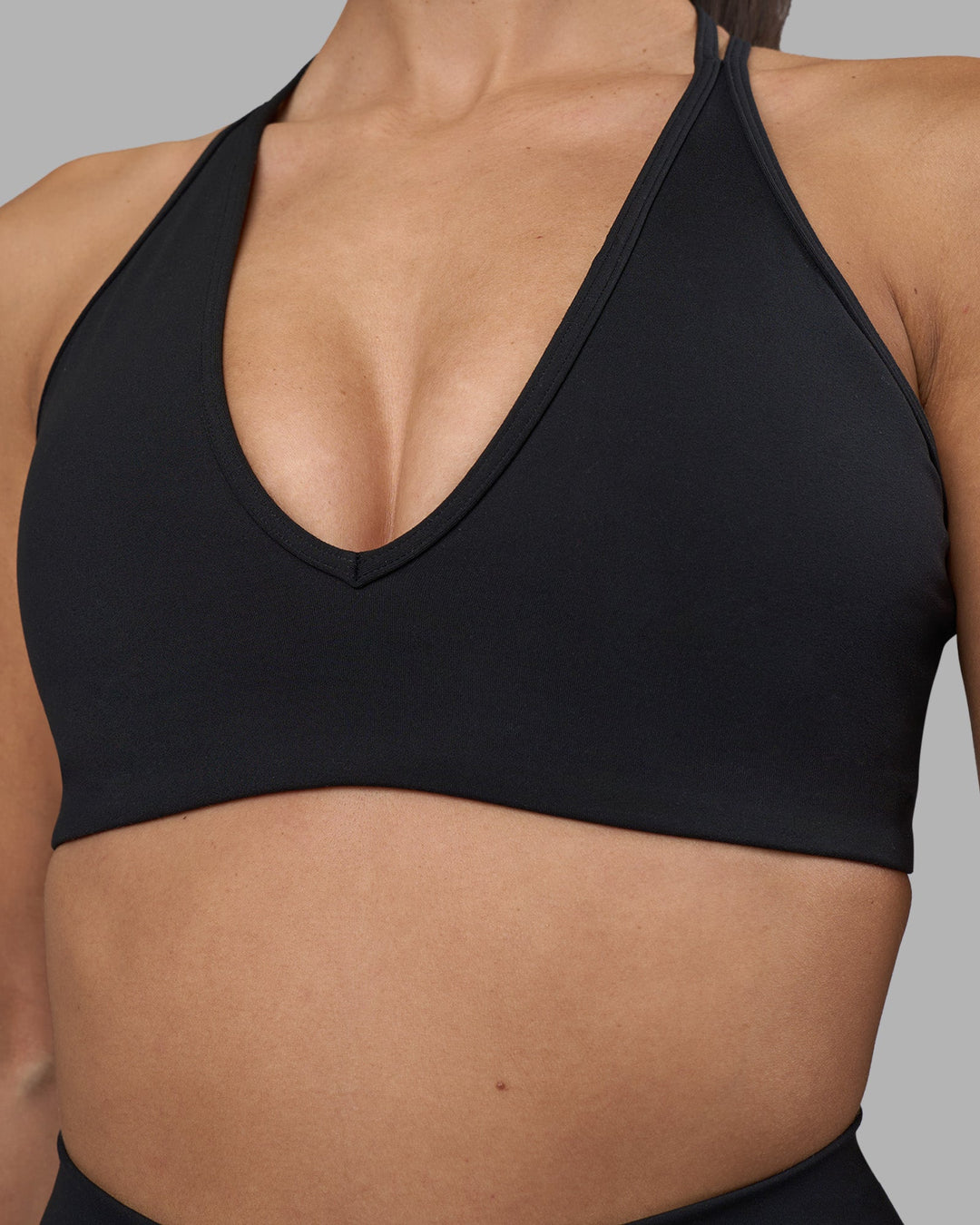 Woman wearing Stamina Pulse Sports Bra - Black | Model:Rhiley | Size:S