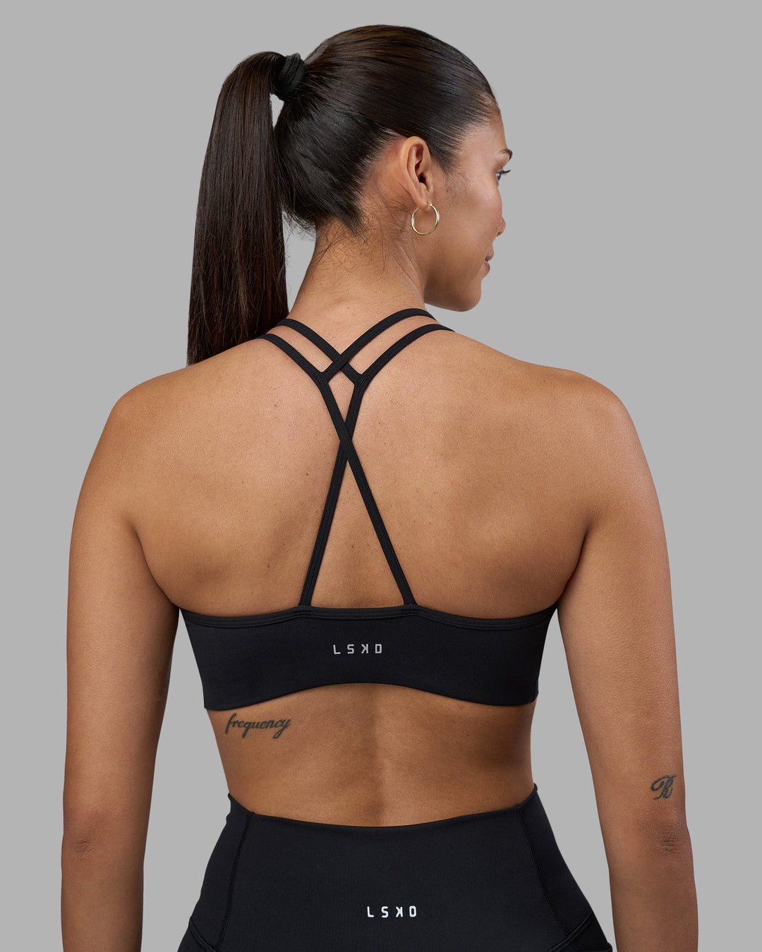 Woman wearing Stamina Pulse Sports Bra - Black | Model:Rhiley | Size:S