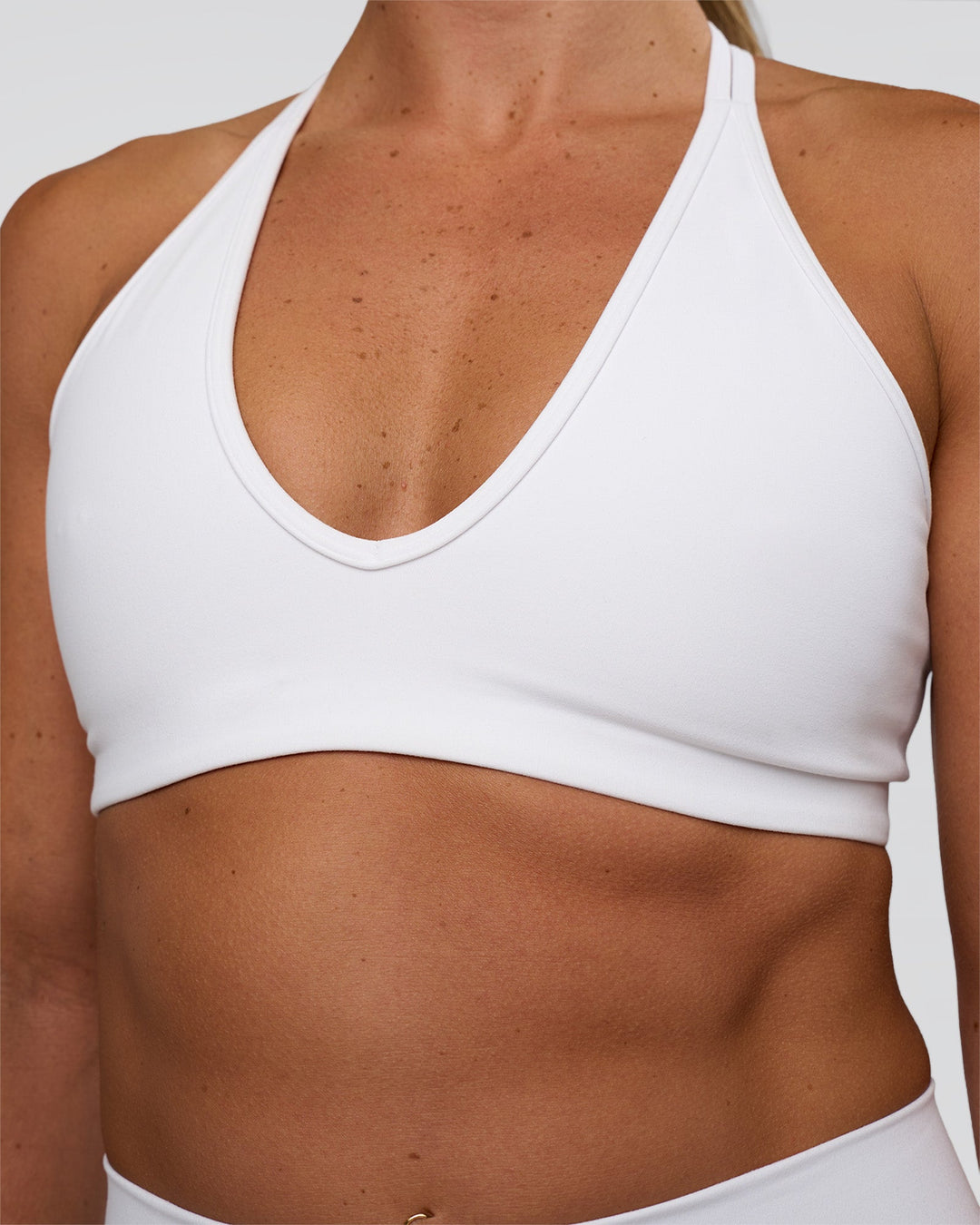 Woman wearing Stamina Pulse Sports Bra - White | Model:Sav | Size:S
