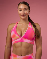 Woman wearing Stamina Rise Sports Bra - Pink Glow Print | Model:Hannah | Size:S