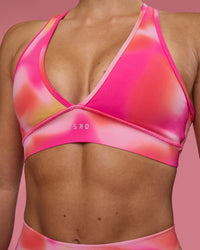 Woman wearing Stamina Rise Sports Bra - Pink Glow Print | Model:Hannah | Size:S