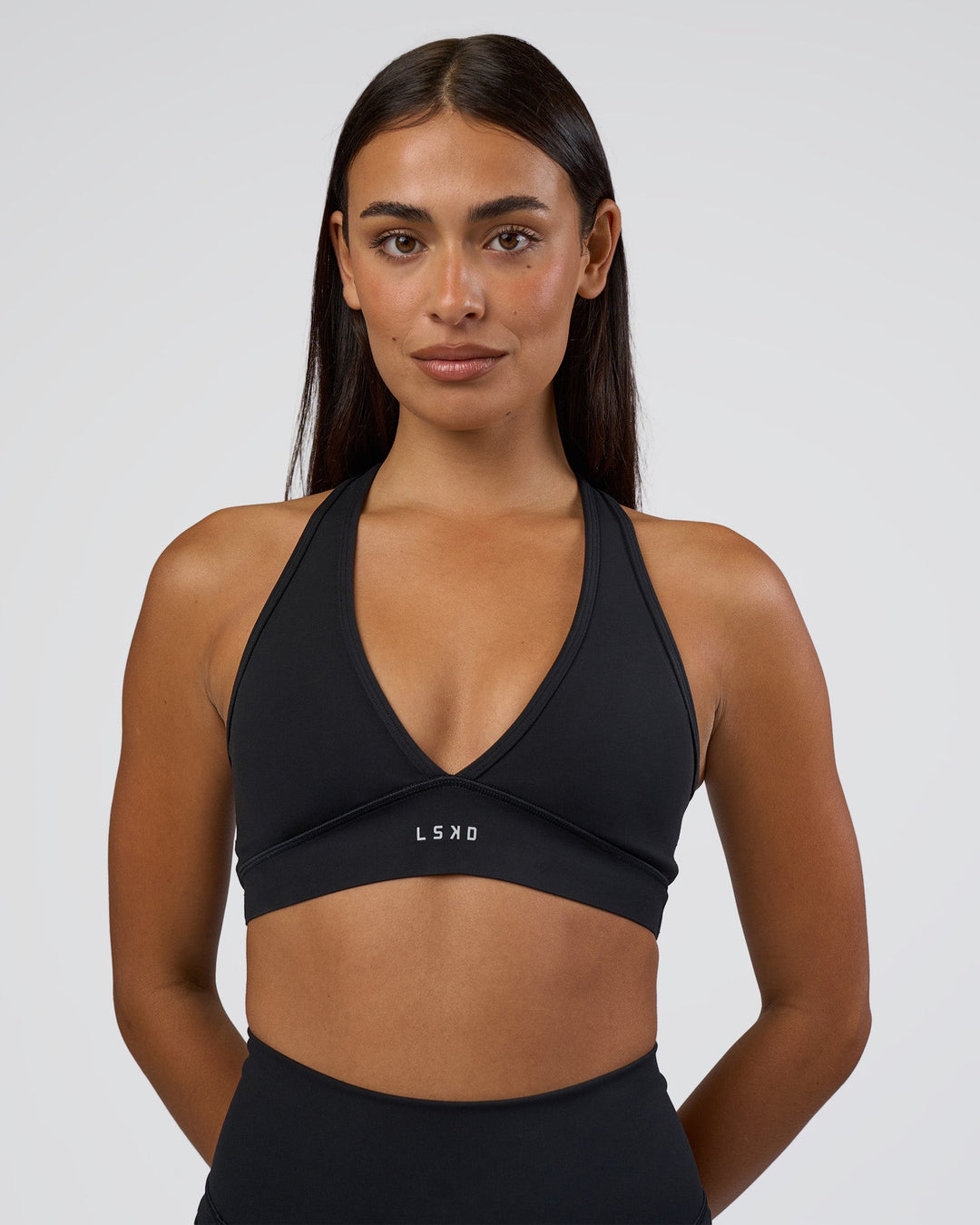 Woman wearing Stamina Sports Bra - Black | Set:true | Angle:front | Model:Ruby | Size:S - view 1