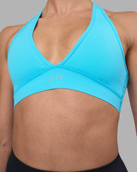 Woman wearing Stamina Sports Bra - Blue Atoll | Set:true | Angle:closeup | Model:Sophie | Size:S