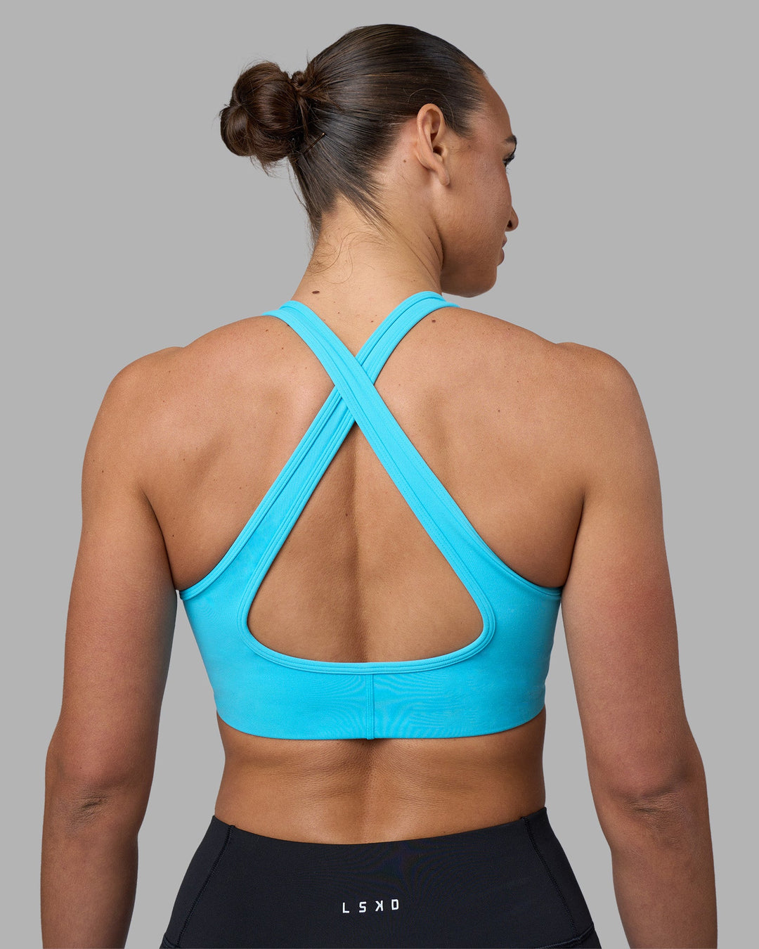 Woman wearing Stamina Sports Bra - Blue Atoll | Model:Sophie | Size:S