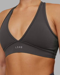 Woman wearing Stamina Sports Bra - Dark Storm | Set:true | Angle:closeup | Model:Keisha | Size:S