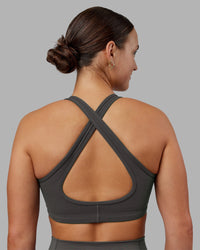 Woman wearing Stamina Sports Bra - Dark Storm | Set:true | Angle:back | Model:Keisha | Size:S