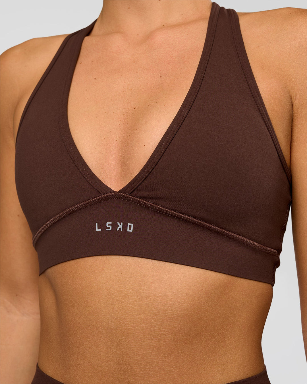 Woman wearing Stamina Sports Bra - Hot Chocolate | Set:true | Angle:closeup | Model:Amity | Size:S - view 1
