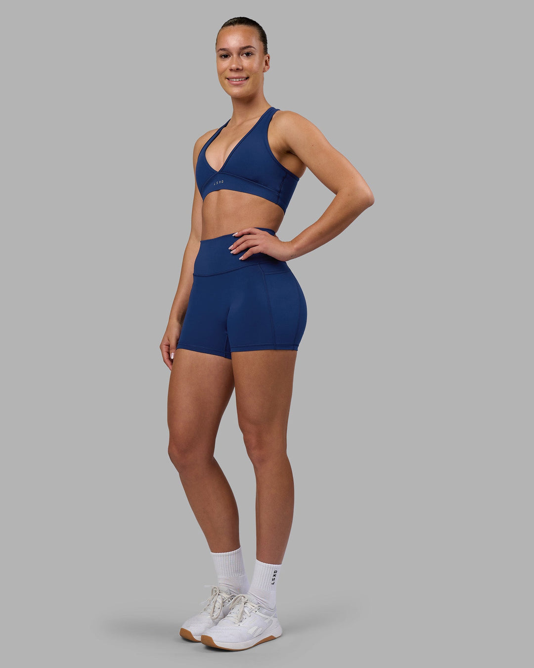 Woman wearing Stamina Sports Bra - Midnight Blue | Model:Charlize | Size:S
