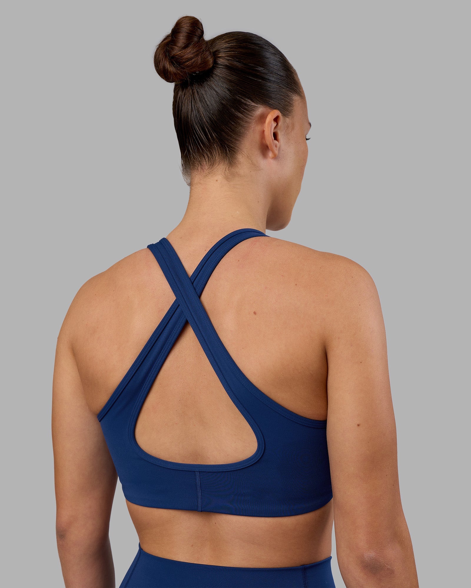 Woman wearing Stamina Sports Bra - Midnight Blue | Model:Charlize | Size:S