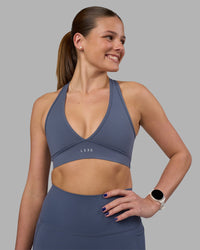 Woman wearing Stamina Sports Bra - Night Shadow | Set:true | Angle:front | Model:Phoebe | Size:S
