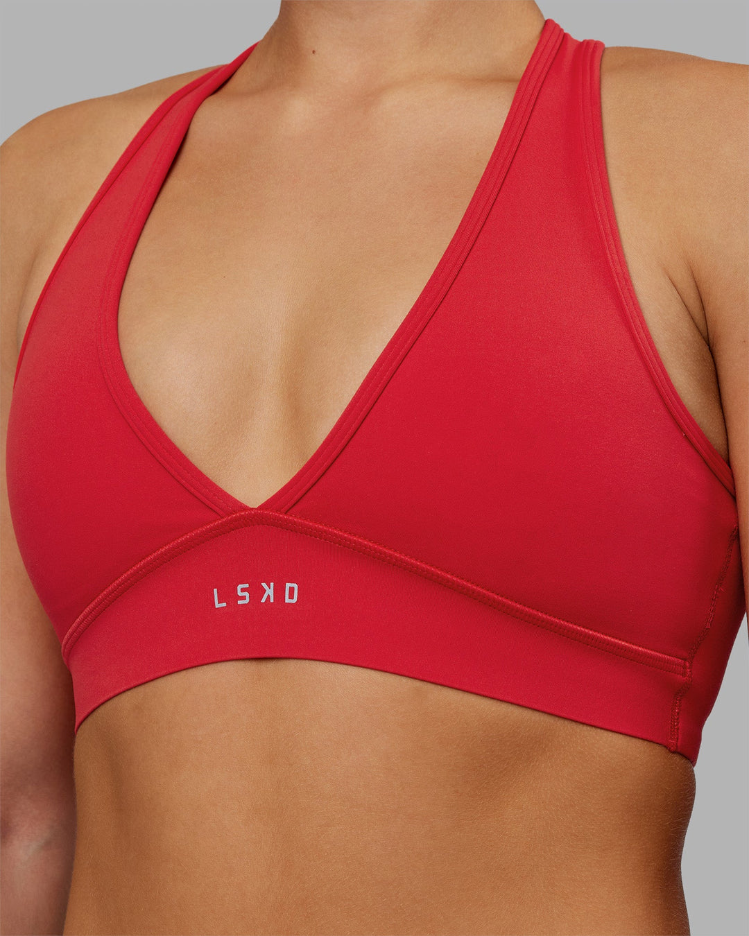 Woman wearing Stamina Sports Bra - Scarlet | Set:true | Angle:closeup | Model:Keisha | Size:S - view 8