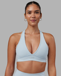 Woman wearing Stamina Sports Bra - Skyride | Set:true | Angle:front | Model:Rhiley | Size:S
