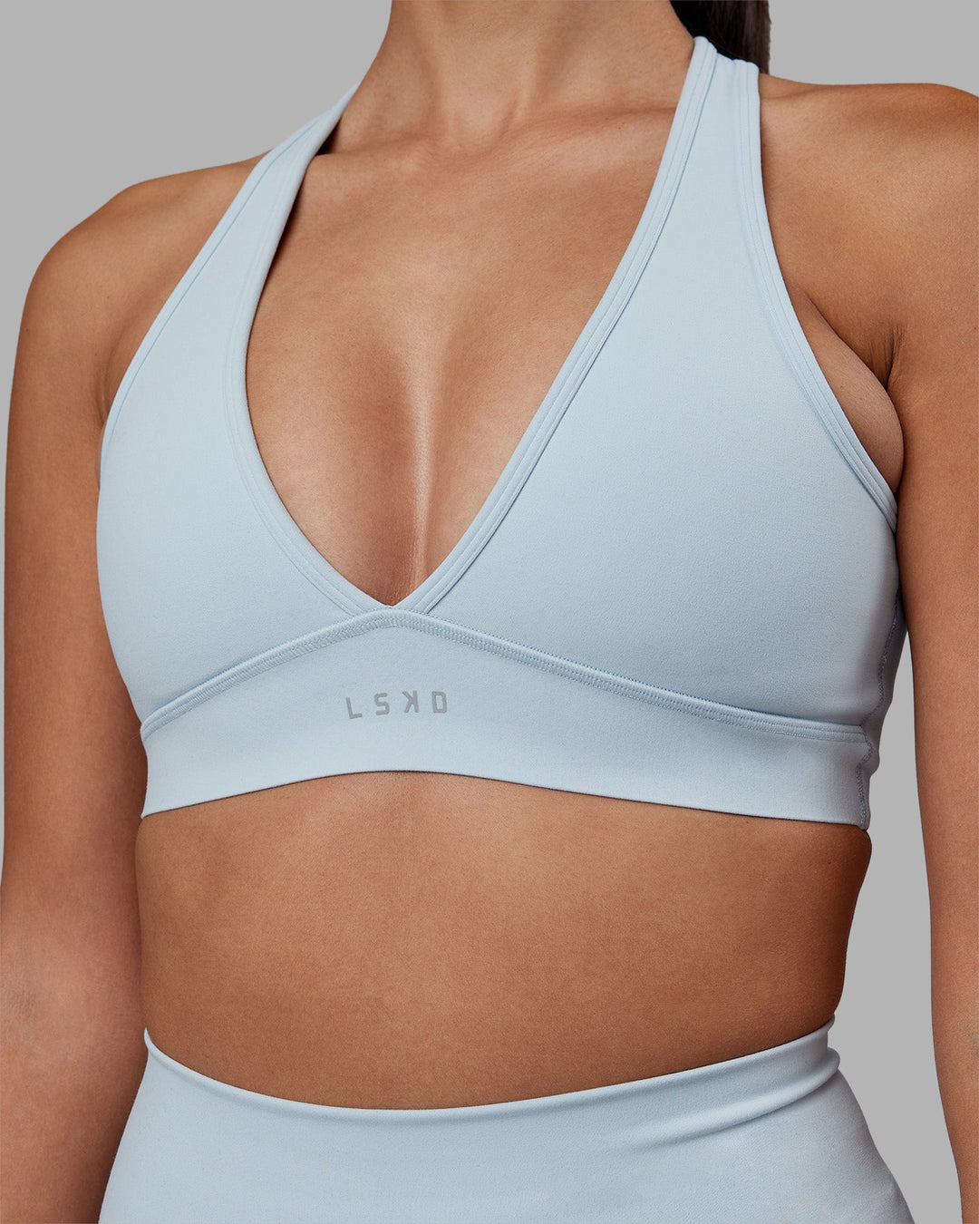 Woman wearing Stamina Sports Bra - Skyride | Model:Rhiley | Size:S