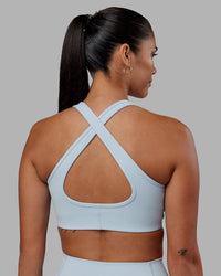 Woman wearing Stamina Sports Bra - Skyride | Set:true | Angle:back | Model:Rhiley | Size:S