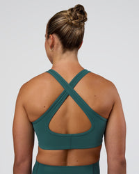 Woman wearing Stamina Sports Bra - Transformative Teal | Set:true | Angle:back | Model:Sav | Size:S