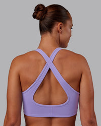 Woman wearing Stamina Sports Bra - Violet Ray | Set:true | Angle:back | Model:Charlize | Size:S | Thumbnail Index: 1
