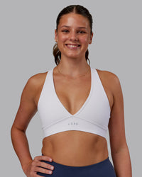 Woman wearing Stamina Sports Bra - White | Set:true | Angle:front | Model:Phoebe | Size:S