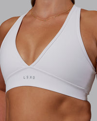 Woman wearing Stamina Sports Bra - White | Set:true | Angle:closeup | Model:Phoebe | Size:S