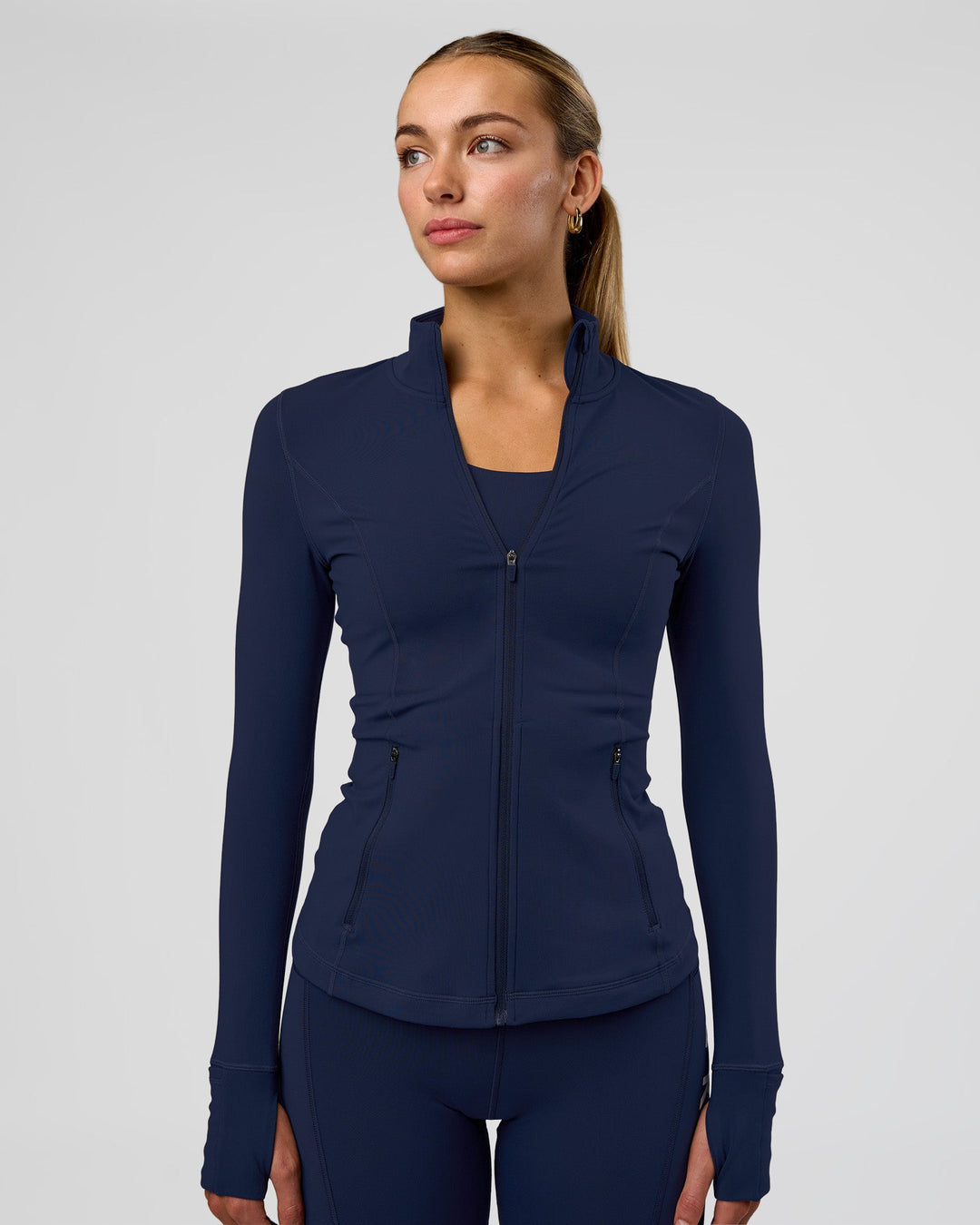 Woman wearing Stride Zip Through Jacket - Future Navy | Model:Evie | Size:S