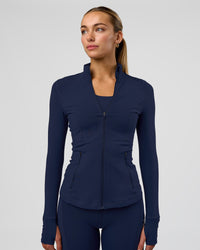 Woman wearing Stride Zip Through Jacket - Future Navy | Model:Evie | Size:S