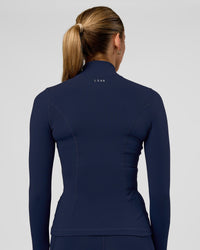 Woman wearing Stride Zip Through Jacket - Future Navy | Model:Evie | Size:S