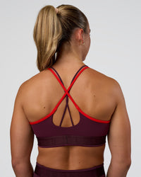 Woman wearing Strive Jacquard Sports Bra - Cherry Lacquer | Model:Sav | Size:S | Thumbnail Index: 1