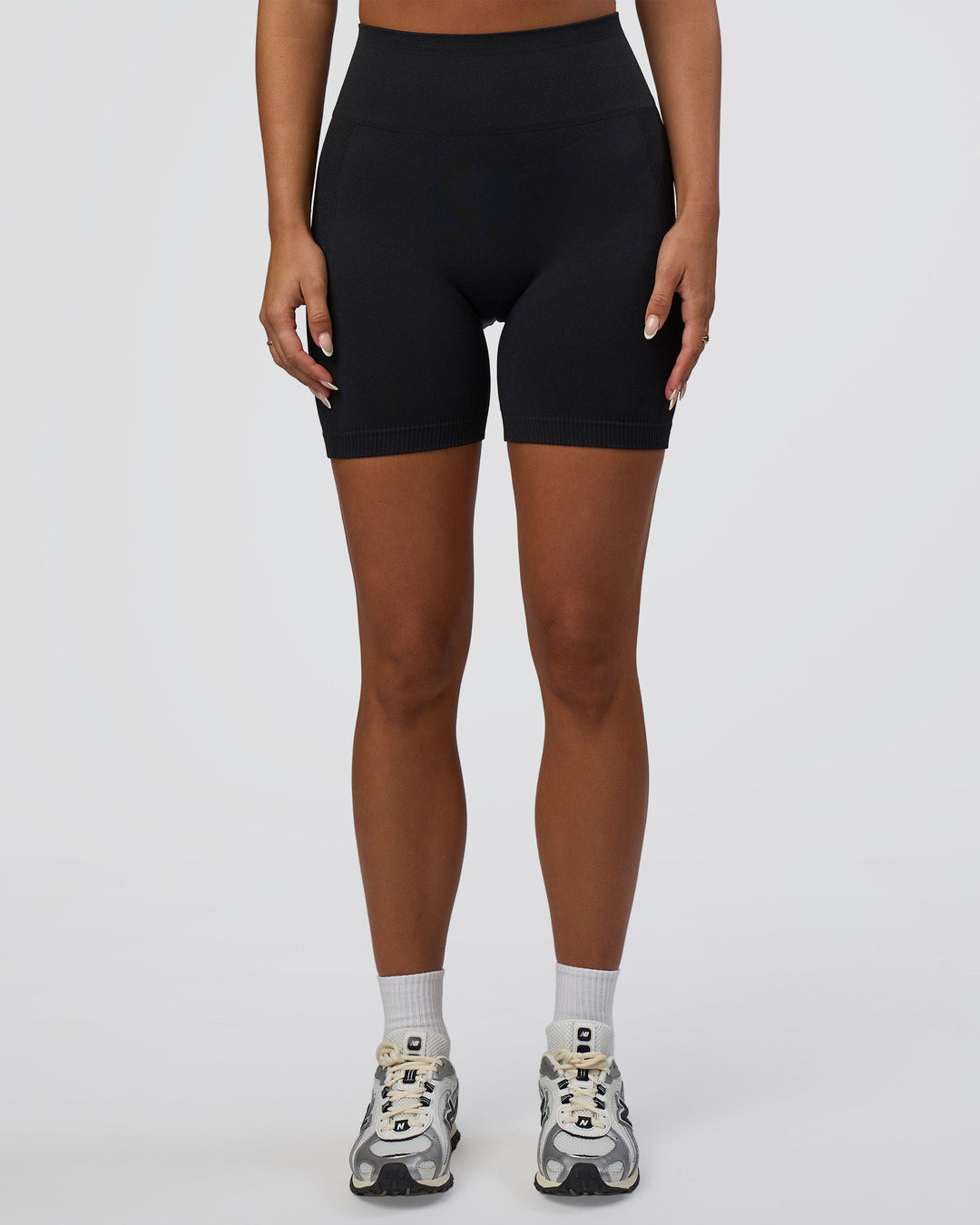 Woman wearing Surge Seamless High-Rise 6" Short - Black | Model:Bianca | Size:S