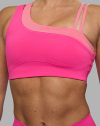 Woman wearing Thrive Asymmetric Sports Bra - Ultra Pink-Candy Pink | Model:Hannah | Size:S