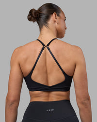 Woman wearing Twist Sports Bra - Black | Model:Sophie | Size:S