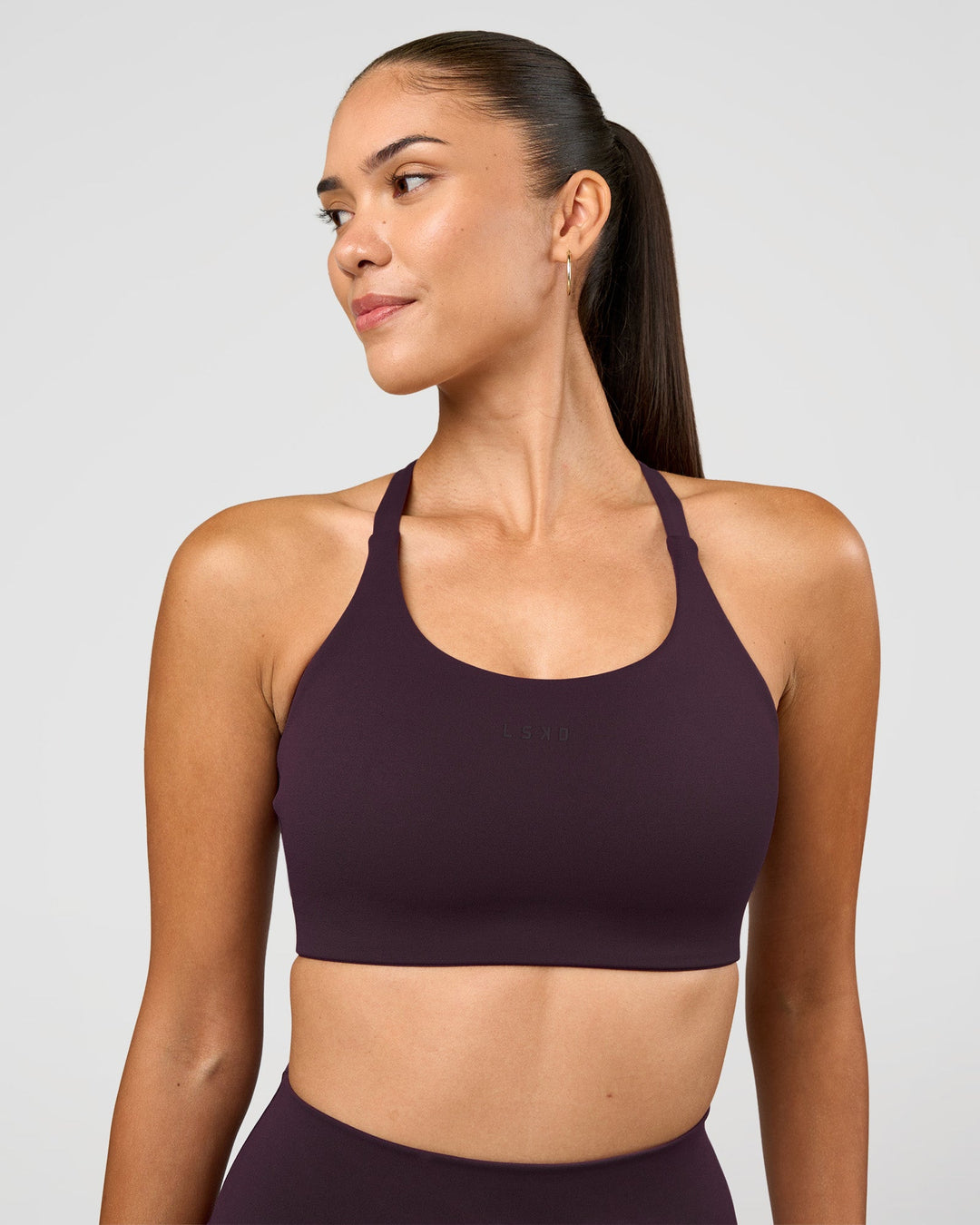 Woman wearing Twist Sports Bra D/DD/E - Midnight Plum | Model:Rhiley | Size:S - view 3