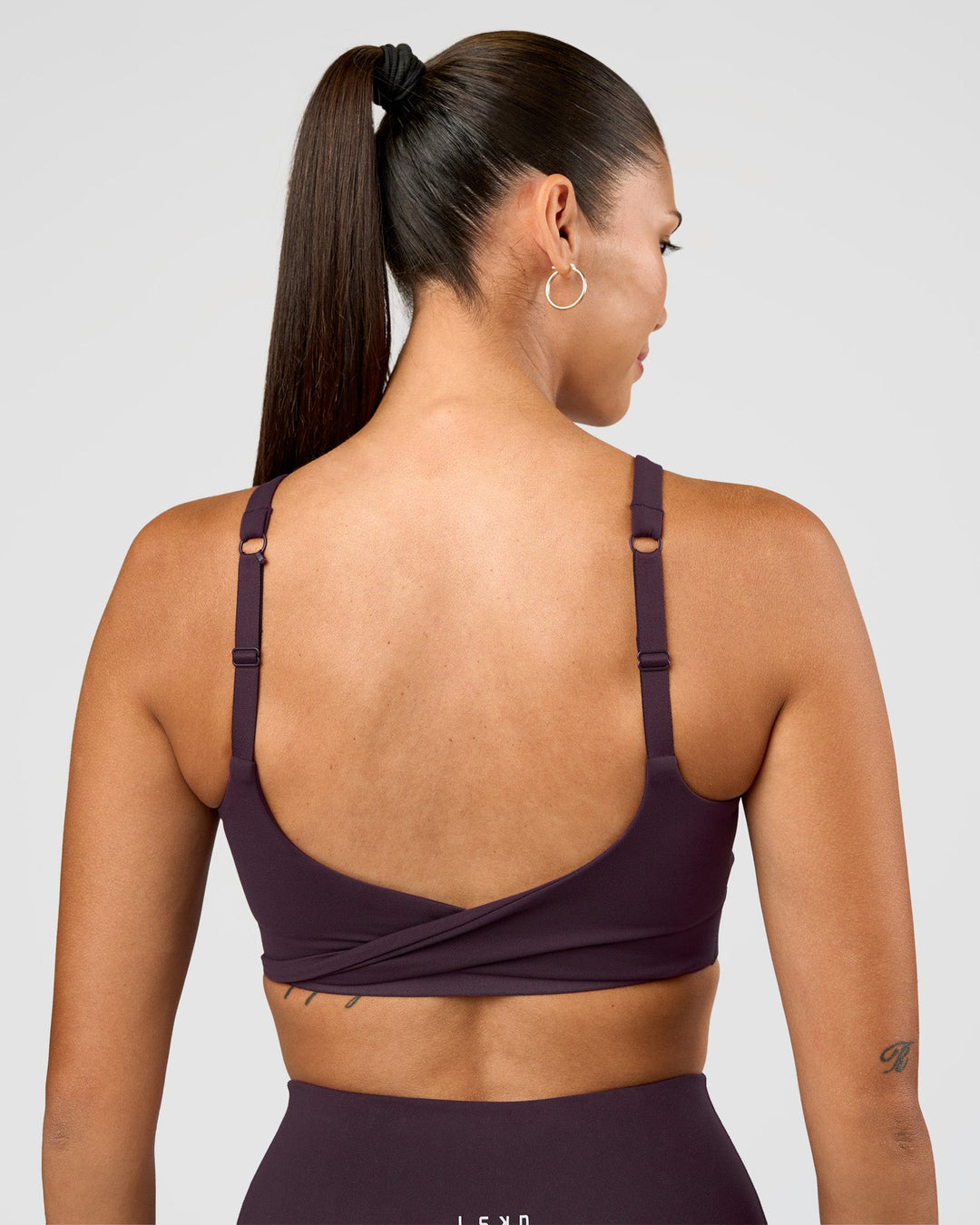 Woman wearing Twist Sports Bra D/DD/E - Midnight Plum | Model:Rhiley | Size:S - view 4
