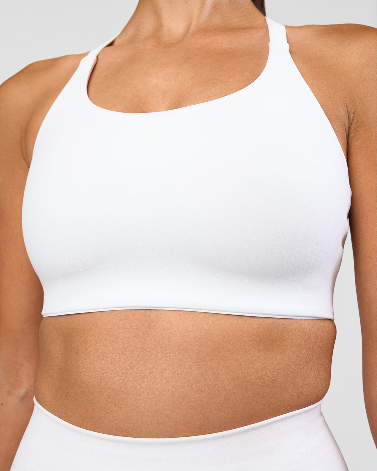 Woman wearing Twist Sports Bra D/DD/E - White | Model:Rhiley | Size:S