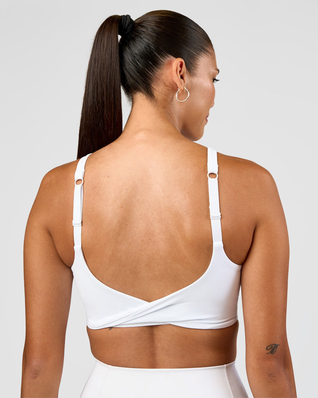 Woman wearing Twist Sports Bra D/DD/E - White | Model:Rhiley | Size:S - view 4