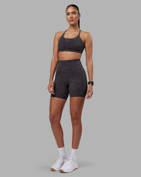 Woman wearing Twist Sports Bra - Dark Storm Wash | Model:Rhiley | Size:S