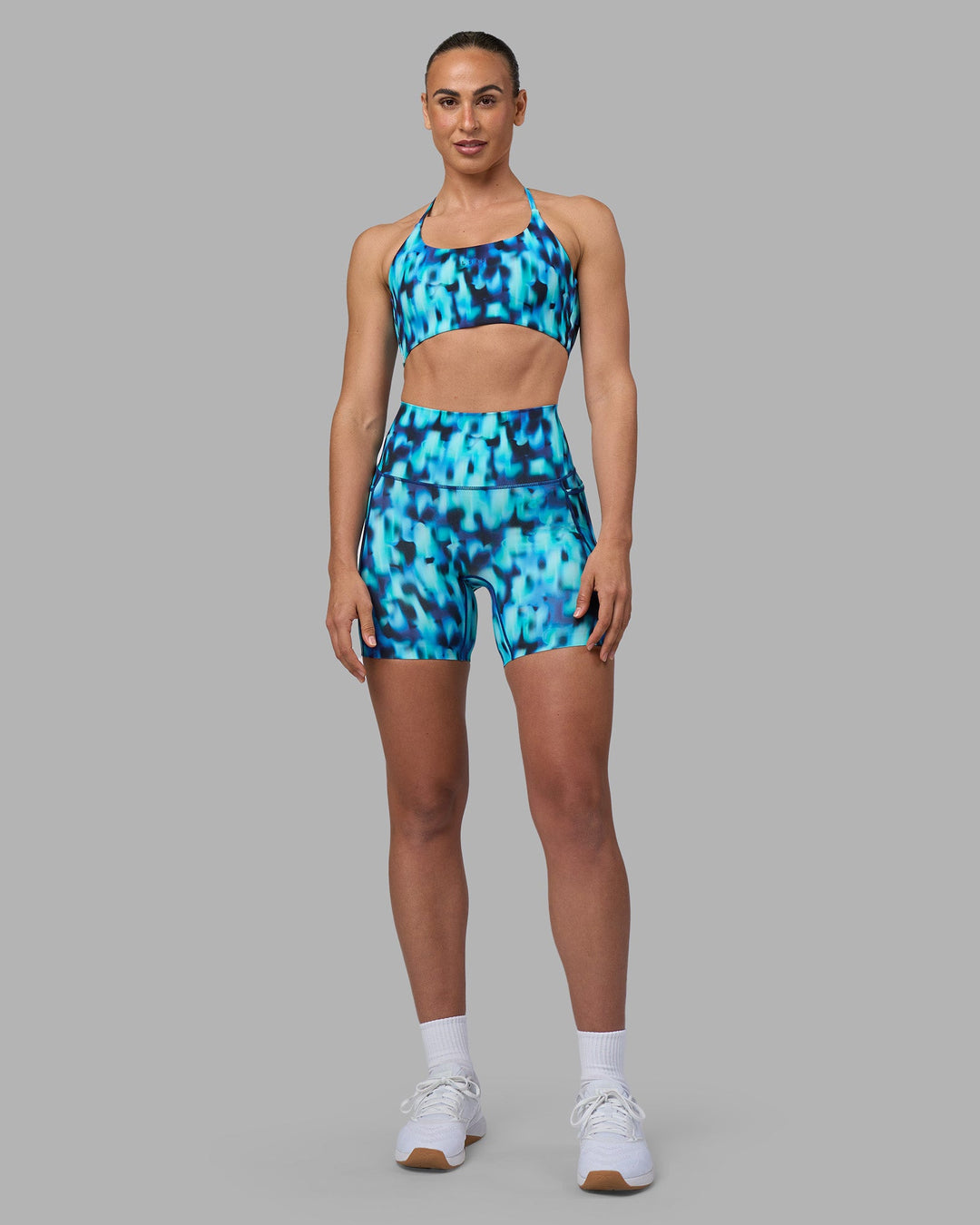 Woman wearing Twist Sports Bra - Luminous | Model:Sophie | Size:S