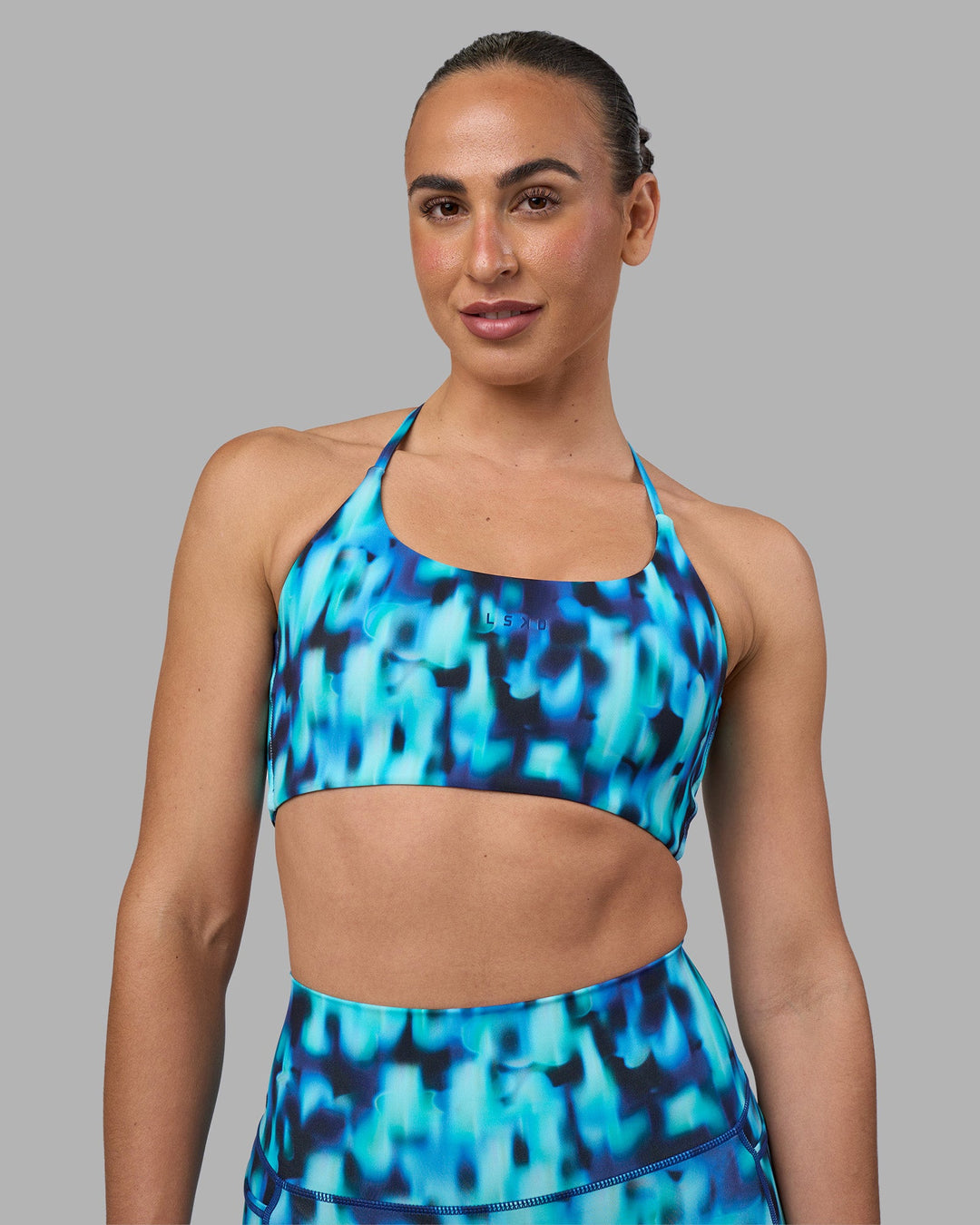Woman wearing Twist Sports Bra - Luminous | Model:Sophie | Size:S